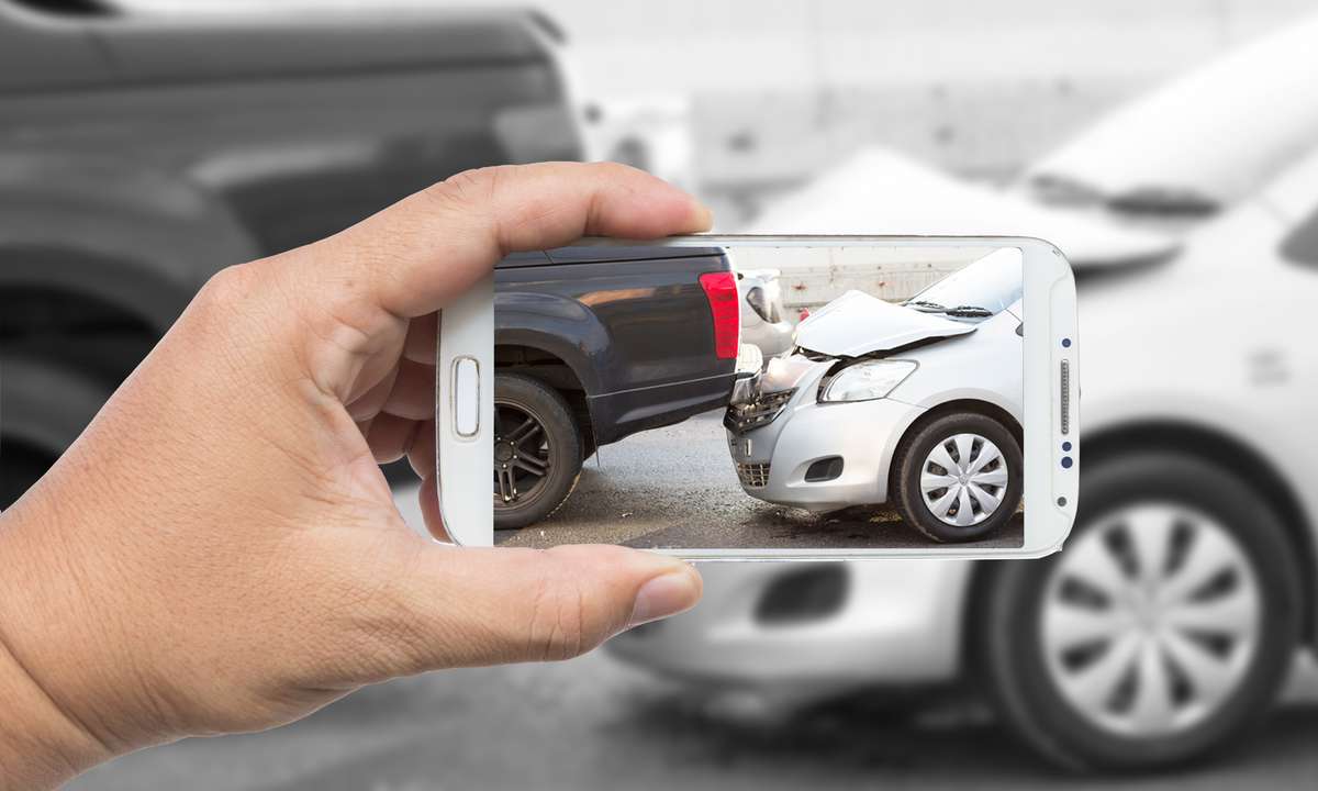 Car accident leads generation guide with actionable strategies for law firms, showcasing a lawyer consulting a client with legal documents on a desk.